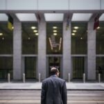 man standing in front of building